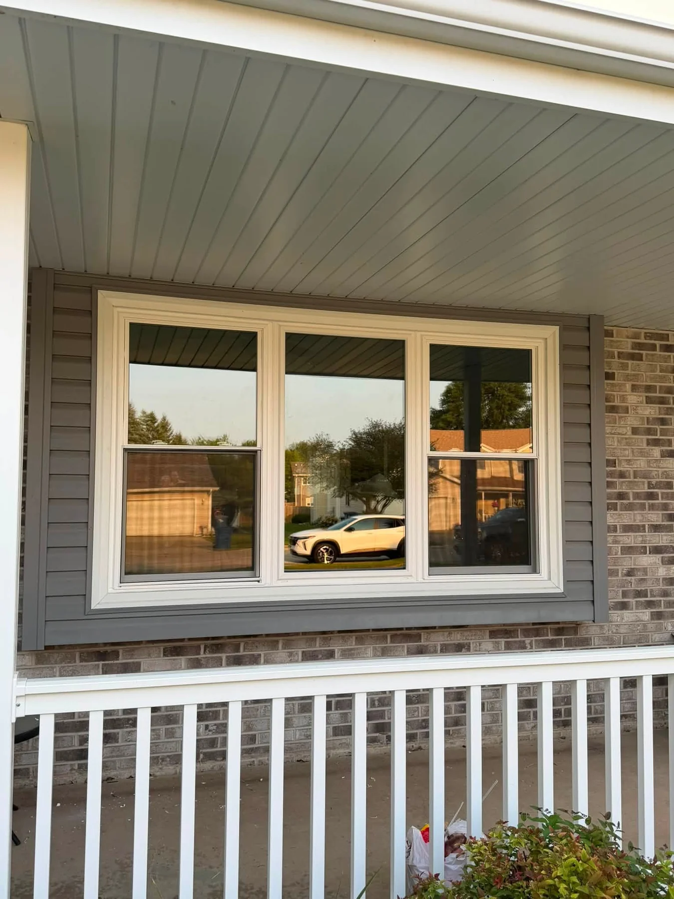 Triple replacement window installed on home exterior
